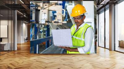 industrial worker busy using laptop at workplace - concept of technology, safety and maintenance eng Wall mural