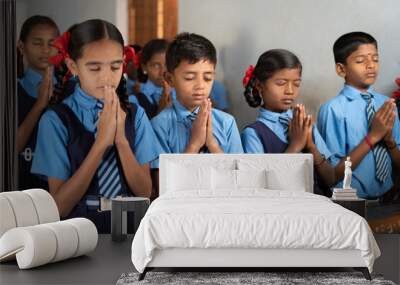 Students at classroom doing morning prayer with closed eyes - concept of wisdom, friendship, development and discipline. Wall mural