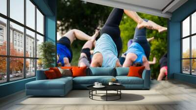 Group of people doing yoga outside Wall mural