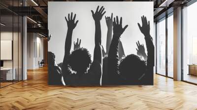 A group of people are raised hands in the air, possibly in a church or a concert Wall mural