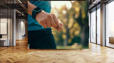 A man is running in a park with his arm raised in the air Wall mural