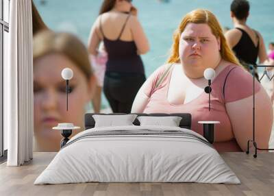 bad vacation, dissatisfied overweight young teenage girl in a bad mood on the beach, fictional person an Wall mural