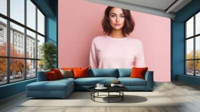 young adult beautiful brunette woman wears a pink pastel style sweater, beauty pretty and comfortable clothes, portrait, front view, close-up Wall mural