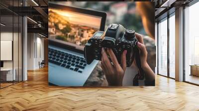 young adult woman holds a photo camera in her hands, a laptop notebook computer screen, photographer looks at the photos on the screen Wall mural