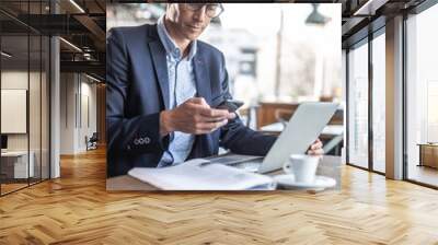 A businessman in a restaurant having coffee and taking care of his business Wall mural