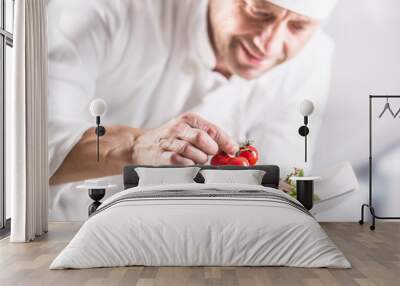 Chef in the kitchen of the hotel or restaurant decorates the food just before serving Wall mural