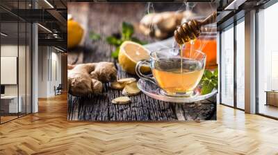 Ginger tea honey lemon and mint leaves on wooden table Wall mural