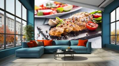 Grilled chicken breast on slate board. Wall mural