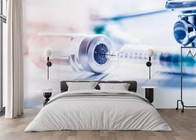 Medical syringe stethoscopeon  on the EKG graph. Wall mural