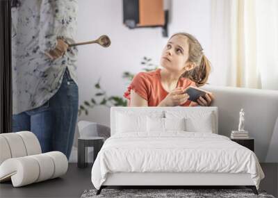 Mother-daughter disagreement with strict mother telling girl off for being online all the time Wall mural