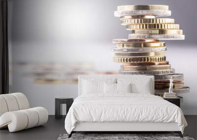 Pile of various coins stacked on an imbalanced column Wall mural