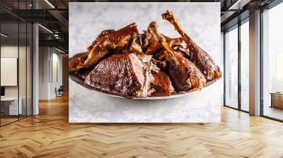 Portioned roast goose on a white plate - Close up Wall mural