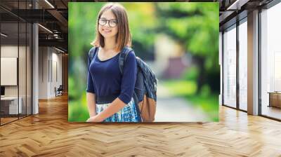 Portrait of attractive young teenage school girl with backpack Wall mural