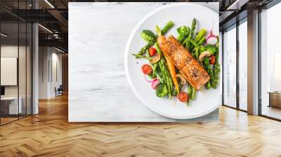 Roasted salmon steak with asparagos broccoli carrot tomatoes radish green beans and peas. Fish meal with fresh vegetable Wall mural