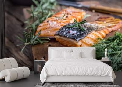 Salmon fillets. Grilled salmon, sesame seeds herb decoration on vintage pan or black slate board. fish roasted on an old wooden table.Studio shot. Wall mural