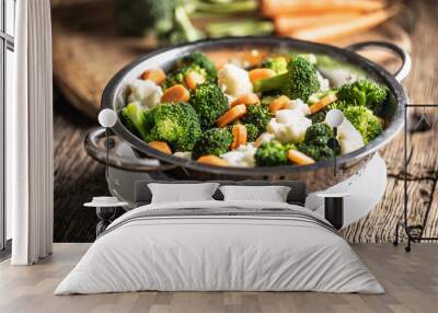 Steamed broccoli, carrots and cauliflower in a stainless steel steamer. Healthy vegetable concept Wall mural