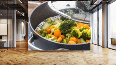 Steamed mixed vegetable in black pot. Healthy vegetable concept Wall mural