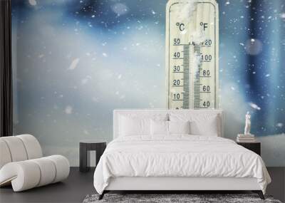 Thermometer on snow shows low temperatures under zero. Low temperatures in degrees Celsius and fahrenheit. Cold winter weather twenty under zero. Wall mural