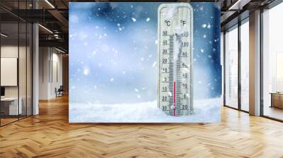 Thermometer on snow shows low temperatures - zero. Low temperatures in degrees Celsius and fahrenheit. Cold winter weather - zero celsius thirty two farenheit. Wall mural