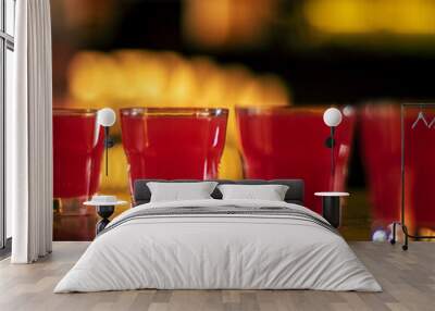 red vodka shots on wooden table square Wall mural