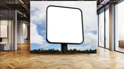 Square white sign with rounded corners. In the background a park and a hill with houses. The background is blurry. Wall mural