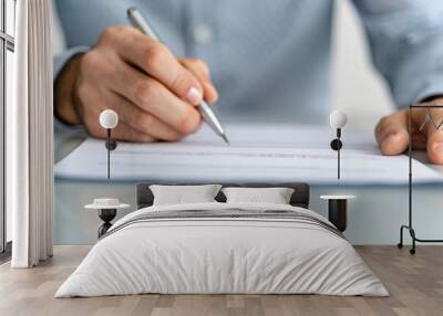 Hand Signing a Document with a Silver Pen Wall mural