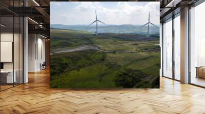 Aerial view of large wind turbines on a rural hillside in Wales Wall mural