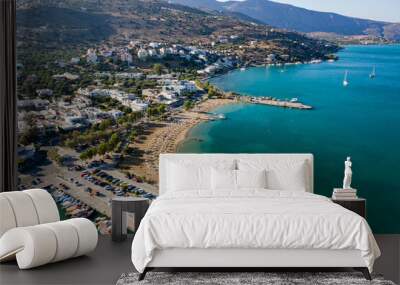 ELOUNDA, CRETE, GREECE - 27 AUGUST 2020: Aerial view of the public beach in the popular Greek tourist town of Elounda on the island of Crete Wall mural