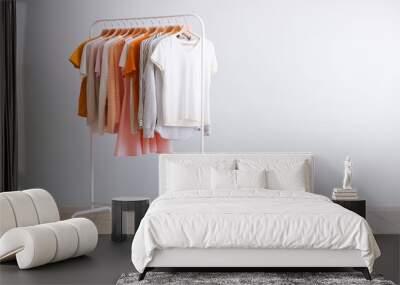 fashion clothes on a rack in a light background indoors. place for text Wall mural