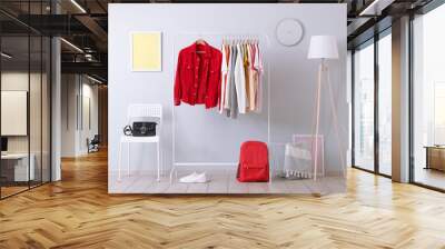 fashionable clothes on a rack in a bright interior of the wardrobe room Wall mural