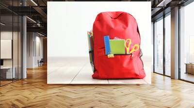 school backpack and stationery in a bright room. Preparing for school. Back to school. Place for text. National School Backpack Awareness Day Wall mural