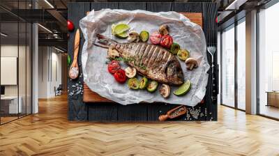 Grilled Dorada fish, sea bream with the addition of spices, herbs and lemon on the grill plate. Wall mural