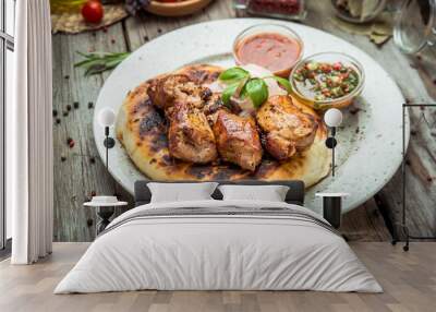 two pieces of of grilled pork with herbs on a paper Wall mural