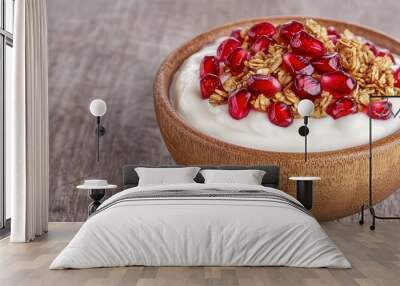 Smooth yogurt topped with juicy pomegranate seeds and granola in a wooden bowl, clean background, natural light, focus on vibrant colors, fresh and healthy. Wall mural