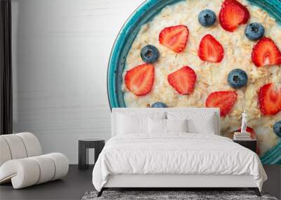 Homemade breakfast . Oatmeal with milk and berries . Top view Wall mural