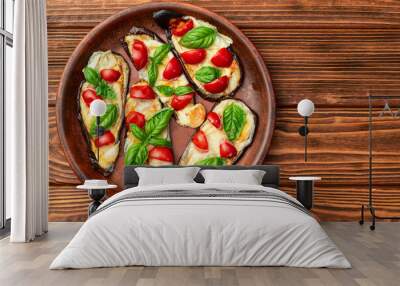 Italian mini pizza . Aubergine (eggplant ) with mozzarella cheese and basil . On rustic background Wall mural