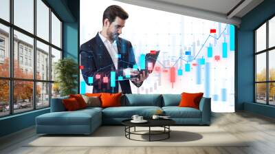 A businessman analyzing digital financial charts on a tablet, with graphical data overlay on white background, concept of market analysis Wall mural