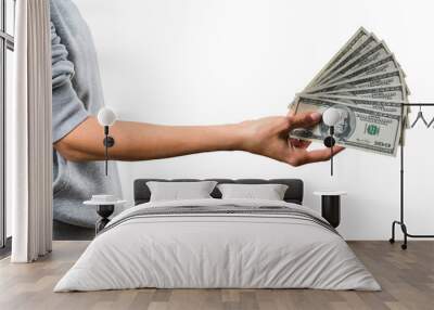 A hand holding a spread of US dollar bills, isolated on a white background, showing the concept of wealth Wall mural