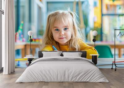 A young girl with blond hair drawing with colored pencils, a bright classroom in the background, concept of early education. Generative AI Wall mural