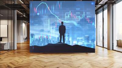 Back view of backlit businessman looking at glowing business forex chart hologram and grid on blurry night city background. Trade, stock, finance and invest concept. Double exposure. Wall mural