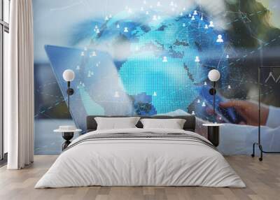 Blockchain and telecommunication concept with digital Earth with glowing citylights and people signs on businessman with smartphone and laptop background Wall mural