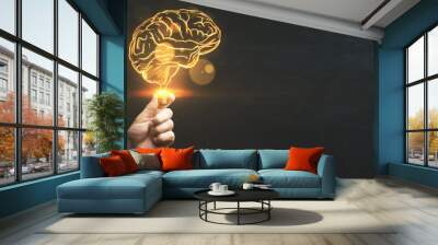 Brainstorm, creative idea and business success concept with digital glowing yellow human brain in man hand on abstract dark blank background with space for your advertising campaign or poster, mock up Wall mural