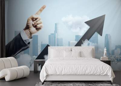 Businessman hand points up and black growing arrow Wall mural