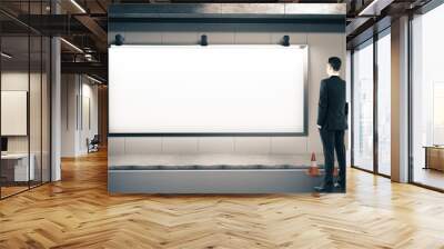 Businessman looking on blank billboard Wall mural