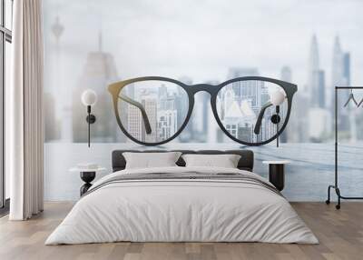 Clear view concept with eyeglasses with transparent lenses on marble surface and blurry city view on background Wall mural