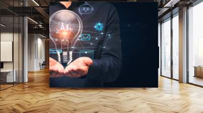 Close up of businessman hand holding glowing ai lamp on dark blue background. Mock up place. Artificial intelligence and future innovations concept. Wall mural