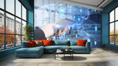 Close up of businessman hand using tabet with abstract glowing map hologram on blurry office interior background. Digital world, transformation and future cyber space concept. Double exposure. Wall mural