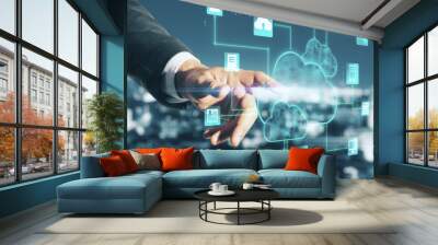 Cloud service concept with man hand touching digital screen with glowing applications icons and cloud sign at blurry city background Wall mural