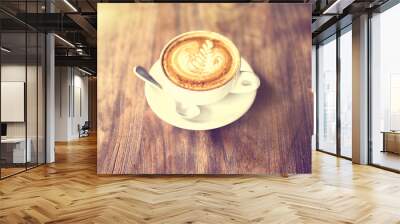 Cup of cappuccino on a wooden table, vintage photo effect Wall mural