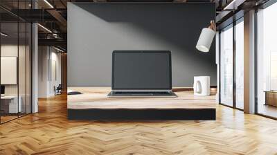 Front view on blank dark modern laptop monitor with place for web design, website or landing page on wooden work table with coffee mug and sunlit black wall background. 3D rendering, mock up Wall mural